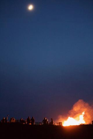 People celebrate on Beltane with a bonfire under the moon